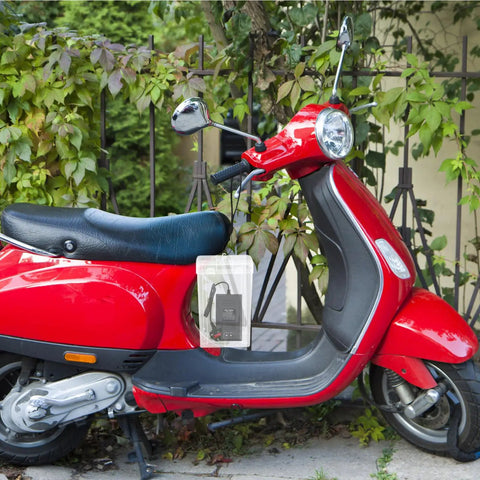 Waterproof Outdoor Outlet Box Cover For Charging Stations Featuring Hella Tough Pp Shield and Quick Install Setup to Keep Your Power Plugs Clean and Weather Ready Year Round hanging from a red scooter in a greenery backdrop.