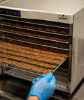 Heavy Duty Food Dehydrator With Digital Thermostat And Set It Forget It Timer six stainless steel trays with jerky being removed.