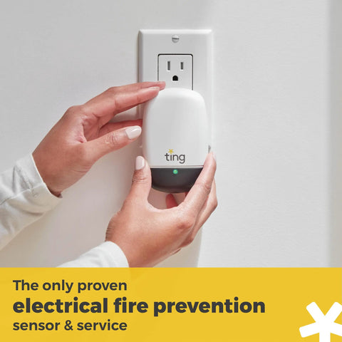 Hands installing Electrical Fire Prevention Sensor And Yearlong Home Service, Cuts Fire Risk Up To 80 Percent, Residential Use Only, 12 Months Included, Easy Safety Upgrade For Your Smart Home into wall outlet.