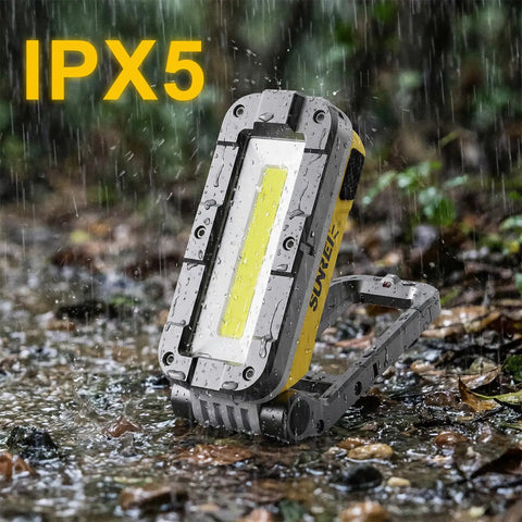 Rechargeable Magnetic Work Light 1200 Lumens With COB LED in use outdoors in wet conditions, featuring IPX5 water resistance.