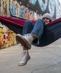 Person relaxing in Double Deluxe Hammock 11 Ft Long, 500 Lb Capacity, Ultra Light Packable Ripstop Nylon, urban graffiti backdrop
