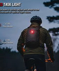 Biker wearing Clip On EDC Ready Rechargeable Pocket Light With 700 Lumen Dual Light Sources, 9 Modes, LED Spotlight And COB Floodlight Plus Red Beam, Magnetic Base, USB-C Charging, Workhorse Ready For Work, Inspection, Camping, Emergency, with red light mode active, during nighttime.