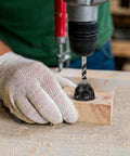 Using No-Nonsense 19mm Dog Hole Chamfer Reamer Bit For Three-Quarters Inch Holes, drilling into wood with electric drill