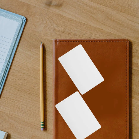 Straight Up Premium White Pvc Cards Bulk Pack Standard Eighty Five By Fifty Four Millimeter Size Ideal For Double Sided Id Printing Custom Employee Badges Smooth Banking Swipes Ready To Roll on leather notebook with pencil.