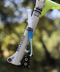 Close-up of Magura Hydraulic Disc Brake Bleed Kit with syringe and hose attached to MTB bike suspension
