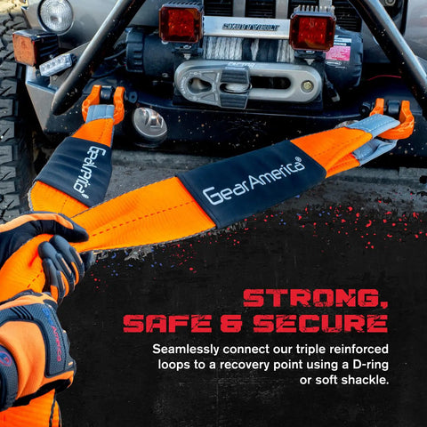Beefed Up Off Road Recovery Kit 9 Ton With Tow Strap Snatch Block Tree Saver D Ring Shackles Winch Line Dampener Bag And Gloves For 4X4 Trucks ATVs UTVs And SUVs Orange being used on a 4x4 vehicle.