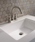 Porter Two Handle Centerset Bathroom Faucet In Brushed Nickel With Mid Arc Spout 7 Inch High, installed on a white sink