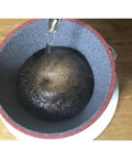 Solid Yellow Ceramic Coffee Filter Reusable Pour Over Dripper Kit With Saucer And Tray For Skip Paper Waste and Smooth Daily Grinds On Your Kitchen Counter with water pouring over coffee grounds.