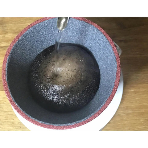 Solid Yellow Ceramic Coffee Filter Reusable Pour Over Dripper Kit With Saucer And Tray For Skip Paper Waste and Smooth Daily Grinds On Your Kitchen Counter with water pouring over coffee grounds.