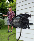 Wall Mount Garden Hose Reel For Outdoor Use, Holds Up To 125 Ft Of Five Eighth Inch Hose, Heavy Duty Aluminum Frame on house wall