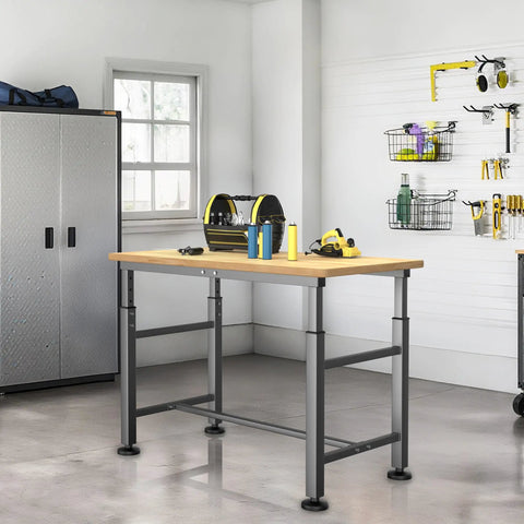 Heavy Duty Garage Workbench With Adjustable 47.5 Inch Height Built Tough Rubber Wood Work Table For Workshop Office Or Home 2000 Lbs Load Capacity Stable Wide Frame And Non Slip Feet in a garage with tools.