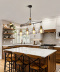 Rustic Lit 4 Light Pendant Lighting for Kitchen Island with clear glass shades in modern farmhouse black metal chandelier.
