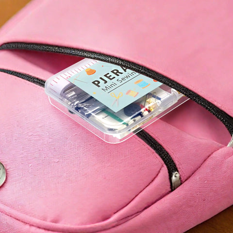 All In One Travel Sewing Kit With Colorful Threads Scissors Needles And A Storage Case shown inside a pink pouch