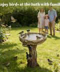 23 Inch Tall Pedestal Bird Bath With Woodland Tree Trunk Decor in garden with birds, fiber reinforced concrete, weatherproof design