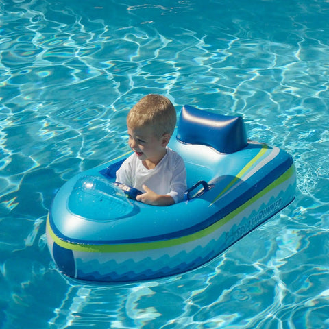 Toddler enjoying Remote Control Baby Pool Float With Enclosed Propeller Guard, blue motorized boat, in a pool, daytime