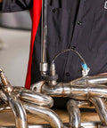 Mechanic using Auto Adjusting Crowfoot Wrench Set Three Piece With Spring Loaded Jaws That Ratchet Each Turn on exhaust pipes