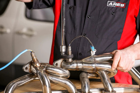 Mechanic using Auto Adjusting Crowfoot Wrench Set Three Piece With Spring Loaded Jaws That Ratchet Each Turn on exhaust pipes