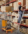CAMMOO hydraulic lift table cart; yellow base with black scissor arms lifting boxes in a warehouse