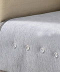 Close-up of bed skirt twist pins with clear heads on fabric, showing secure hold for upholstery and slipcovers, neat appearance