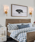 Bedroom with set of 2 modern wall sconces with creamy white fabric flower shades and antique brass brush finish for bedside lighting