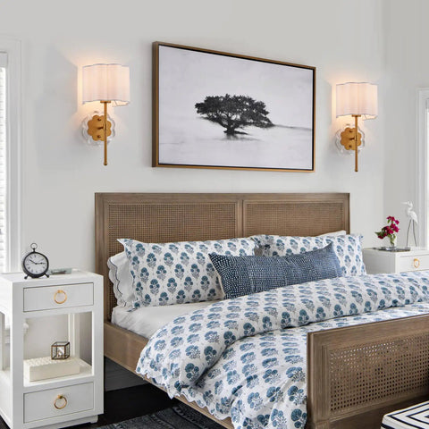 Bedroom with set of 2 modern wall sconces with creamy white fabric flower shades and antique brass brush finish for bedside lighting