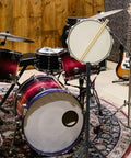 Badass Adjustable Snare Drum Rack And Practice Stand With Rock Solid Non Slip Base Plus Straight Up Portable Double Drumstick Shelf And Quick Hinge Height Adjustment For Pro Music Gear amidst a colorful drum set.
