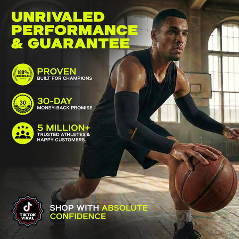 Man playing basketball indoors wearing black arm sleeves for men and women with UV protection and cooling compression.