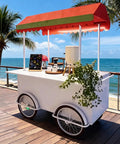 Hustle Made Easy With This Heavy Duty Outdoor Vending Cart, weatherproof canopy, and spacious prep counter by the beach.