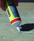 Concrete Repair Patch And Crack Filler, Premixed Cement Repair In Gray, 5.5 Oz Squeeze Tube being applied to concrete surface