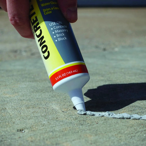 Concrete Repair Patch And Crack Filler, Premixed Cement Repair In Gray, 5.5 Oz Squeeze Tube being applied to concrete surface