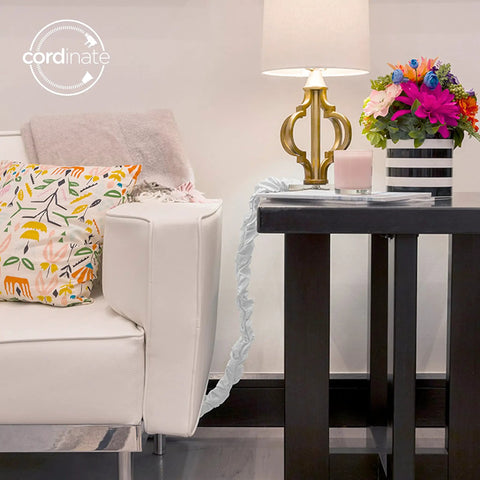 Fabric Cord Cover 6 Ft Conceals Cables From Lamps, Light Fixtures And Desks, Easy Hook And Loop Installation, Cable Management Sleeve In Eggshell White For Neat Low Profile Wires next to sofa and table.