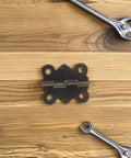 Antique Decorative Butterfly Hinges Set Of 24 For Jewelry Boxes And Cabinets on wooden surface with wrench