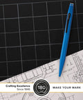 Tech2 Metallic Blue All In One Ballpoint Pen With Built In Stylus, Medium Point, Black Ink, Smooth Glide Write, Ergonomic Grip, Durable Metal Body For Everyday Carry lying on blueprint paper