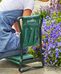 Do It All Garden Kneeler Seat With Padded Cushion And Detachable Tool Bag used while gardening by a person tending flowers
