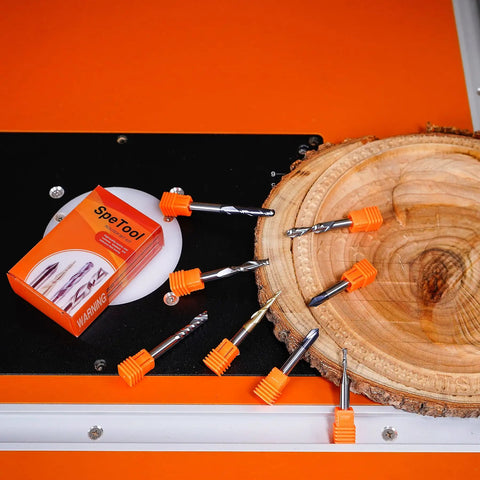 Carbide CNC Router Bits Set With Quarter Inch Shank displayed on wood slab for woodworking detail carving and trimming.
