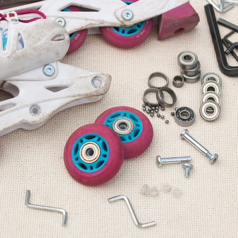 Deep Groove Ball Bearings Set 5x8x2.5mm For Rollers And Skateboards with tools and wheels on beige background