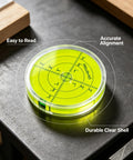 Magnetic Round Bubble Level Tool Bullseye Inclinometer Machinist on a surface with clear measurement grid and durable shell.