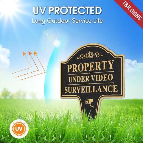 Heavy Duty Property Under Video Surveillance Sign For Outdoor Yard Warning 2 Pack 14 By 10 Inch Rust Free Aluminum Plate in green grass.