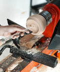 Person using Heavy Duty Woodturning Hollowing Tool With Replaceable Carbide Tipped Round Blade And Solid Beech Handle on wooden lathe.
