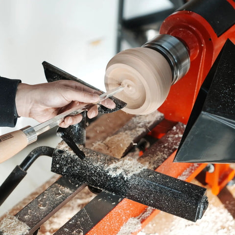 Person using Heavy Duty Woodturning Hollowing Tool With Replaceable Carbide Tipped Round Blade And Solid Beech Handle on wooden lathe.