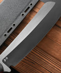 Close-up of Rugged Fixed Blade Knife With DC53 DLC Coated Nine Point Eight Four Inch Blade Carbon Fiber Handle beside sheath