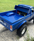 RC Crawler C24 4x4 Off Road Truck RTR 1/16 Scale shown in blue with open truck bed on grass, featuring realistic details.