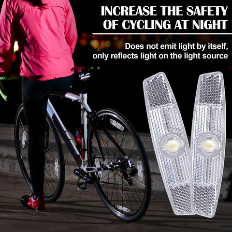 Cyclist at night with bicycle featuring Six Piece Bicycle Spoke Reflectors White Safety Wheel Reflectors Set for Road and Mountain Bikes.