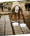 Worker using Medium Hole Tiles Concrete Mold For Stepping Stones, Reusable DIY Garden Path And Patio Paver Maker, 10.62 X 10.62 X 2.36 In