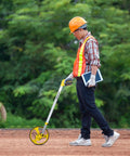 Heavy Duty Gear Driven Measuring Wheel With Tough Plastic Housing And Five Digit Counter Built Like A Tank With Quick Fold Handle And Kickstand Diecast Aluminum Wheel Aces Road Layouts Mw40M in use by a worker outdoors.