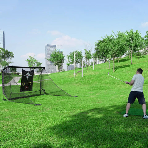 Person using Indoor Outdoor Golf Practice Net 10x7ft With Target Mat And Chipping Cage Backyard Driving Range in a park setting.