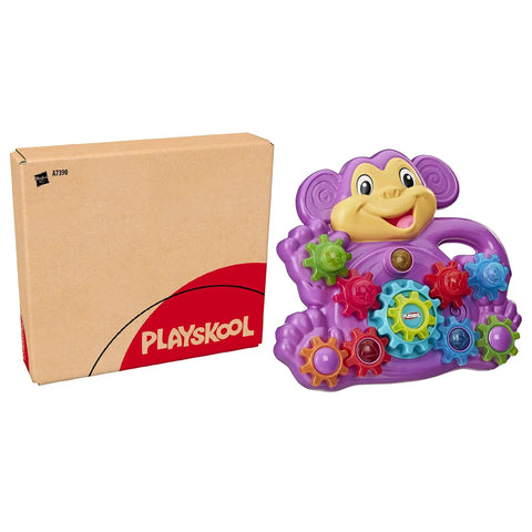 Totally Awesome Dope Monkey Gears Stacking And Spinning Toy With Nine Interchangeable Plastic Cogs next to its box.