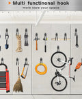 Multi tool hooks on wall storing tools, bicycle, and ladder in organized garage space