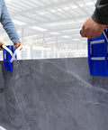 Two workers using 2-Pack Stone Granite Carrying Clamps Handed Panel Carriers for Granite and Marble Panels in a warehouse.