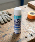 Uonlytech Reflective Hazard Marking Spray, Industrial Safety Warning Paint can on a workbench with gloves and tape.